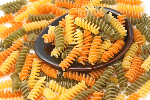 Pile of Pasta fusilli in black bowl — Stock Photo, Image