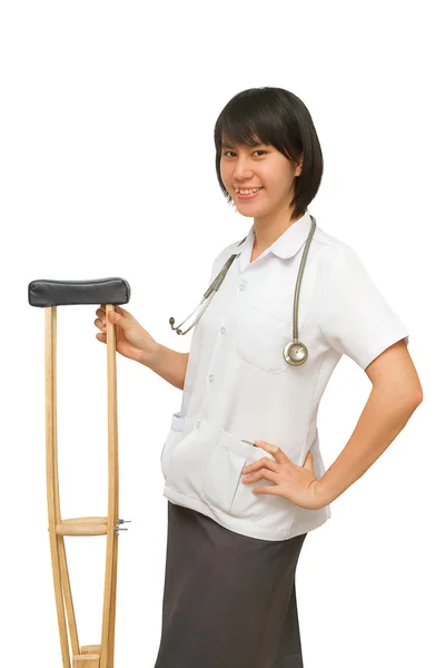 Smiling medical doctor holding crutches — Stockfoto