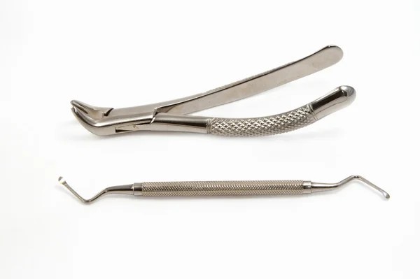 Dentist extraction forceps and dental equipment on white backgro — Stock Photo, Image