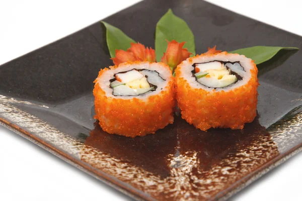 Traditional Japanese food Sushi on black plate — Stock Photo, Image