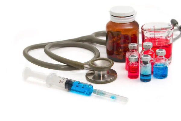 Medical bottles, ampoule, syringe and pills with stethoscope — Stock Photo, Image