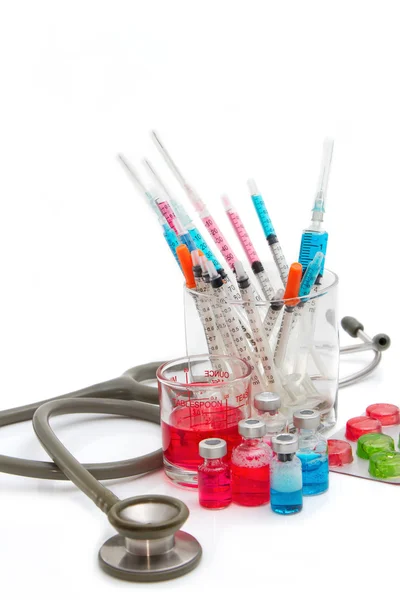 Medical bottles, ampoule, syringe and pills with stethoscope — Stock Photo, Image