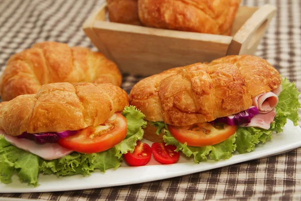 Croissant skinksmörgås med färska grönsaker — Stockfoto