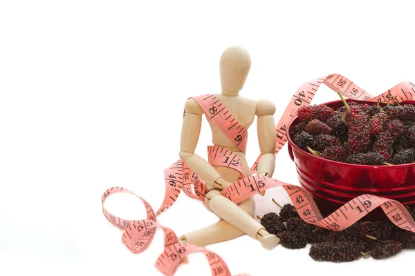 Fresh mulberry and measure tape on wooden model — Stock Photo, Image