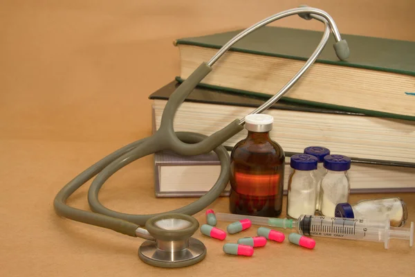 Stethoscope and medications on medical book — Stock Photo, Image