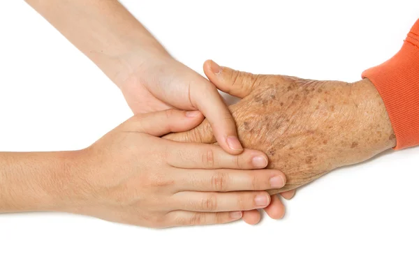 Mayores y jóvenes tomados de la mano — Foto de Stock