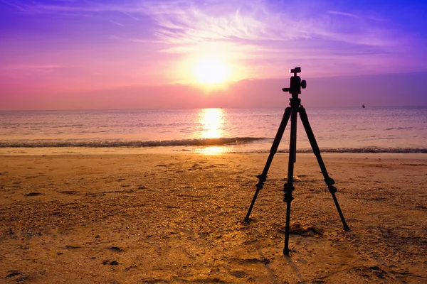 Tripod over sun rising near the beach — Stock Photo, Image