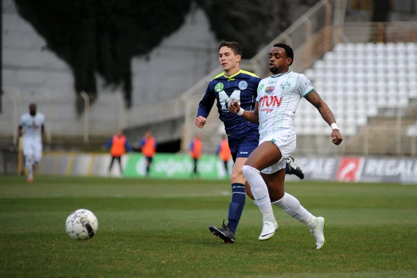 KAPOSVAR, HUNGARY - MARCH 16: Mulemo Landry (in white) in action at a Hungarian Championship soccer game - Kaposvar (white) vs Puskas Akademia (blue) on March 16, 2014 in Kaposvar, Hungary. — Stock Photo, Image