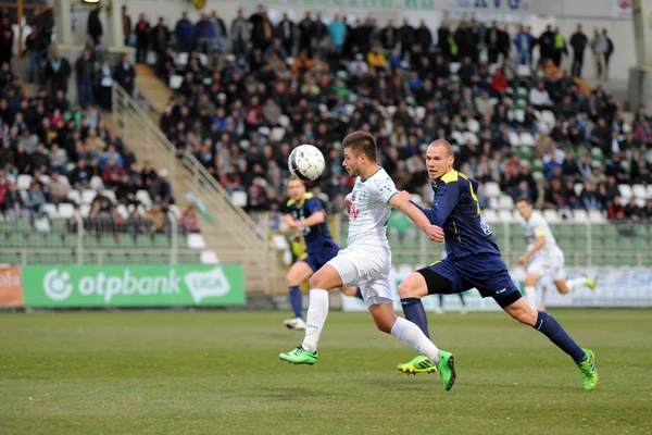 KAPOSVAR, HUNGARY - MARCH 16: Firtulescu Dragos Petrut (white 10) in action at a Hungarian Championship soccer game - Kaposvar (white) vs Puskas Akademia (blue) on March 16, 2014 in Kaposvar, Hungary. — Stock Photo, Image