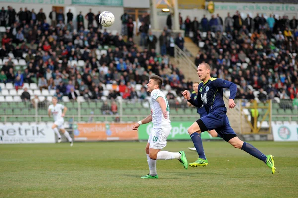 Kaposvar, Macaristan - 16 Mart: firtulescu dragos petrut (beyaz 10) eylem Macaristan Ligi futbol maçı - kaposvar (beyaz) vs puskas akademia (mavi) üzerinde 16 Mart 2014 yılında kaposvar, Macaristan.