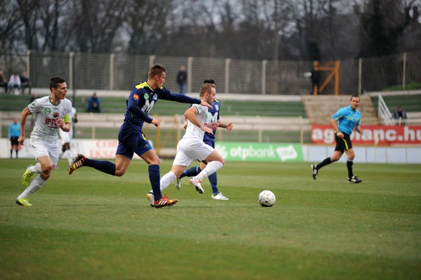 KAPOSVAR, HUNGARY - MARCH 16: Florean Andrei-Alexandru  (white) in action at a Hungarian Championship soccer game - Kaposvar (white) vs Puskas Akademia (blue) on March 16, 2014 in Kaposvar, Hungary. — Stock Photo, Image