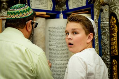 Bar Mitzvah celebration in the city synagogue. A young man conducts a festive bar mitzvah ceremony. Israeli village Shlomi June 29, 2022