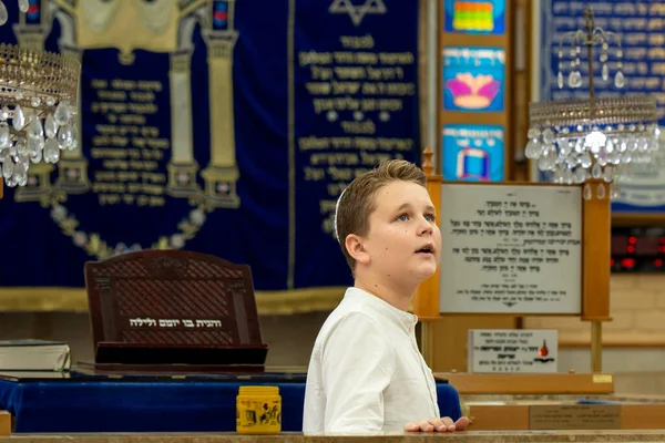Bar Mitzvah celebration in the city synagogue. A young man conducts a festive bar mitzvah ceremony. Israeli village Shlomi June 29, 2022