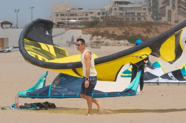 Kitesurfing. Surfers of all ages train in the Mediterranean. Israel, Ashkelon, July 2022. Training continues. Sport, health, recreation concept