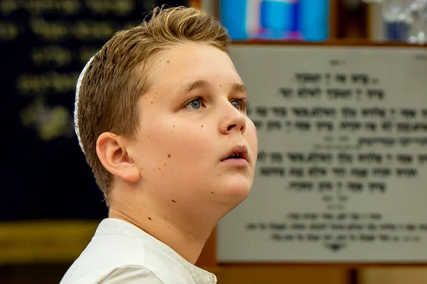 Celebrating a bar mitzvah in the city synagogue. Portrait of a boy. A young man performs a festive bar mitzvah ceremony. Israeli village Shlomi June 29, 2022