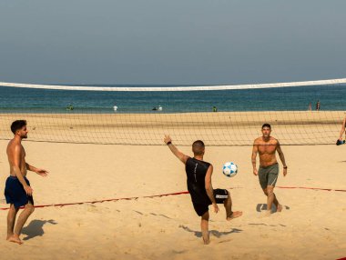 Young people gathered to play volleyball with their feet on the city beach. Israel Ashkelon November 2020