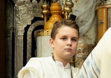 Bar Mitzvah celebration in the city synagogue. Portrait of a boy who is at the bar mitzvah ceremony. Israeli village Shlomi June 29, 2022