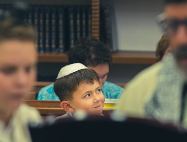 Celebrating a bar mitzvah in the city synagogue. Portrait of a boy. A young man performs a festive bar mitzvah ceremony. Israeli village Shlomi June 29, 2022
