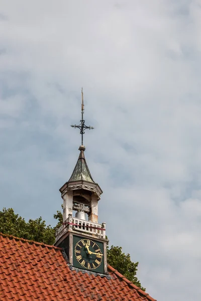 Little bell tower on the roof of the church with clock