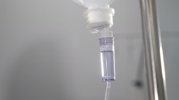Infusion dripping. Medical IV Drop Rate. medical dropper close up. Drop counter with medicine. Transparent dropper with medical liquid dribbling down in hospital ward. treatment of patients — Stock video