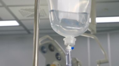 Infusion dripping. Medical IV Drop Rate. medical dropper close up. Drop counter with medicine. Transparent dropper with medical liquid dribbling down in hospital ward. treatment of patients