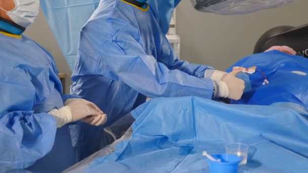 Vascular surgery in modern clinic. wound on arm. Surgeons using surgical tools during operation varicose veins, Radiologist performs endovascular operation with angiography machine. Cardio-vascular — Vídeo de Stock
