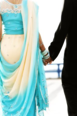 indian bride and groom walking away together