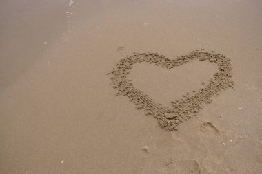 Heart on the sand. Sea love concept. Copy space.