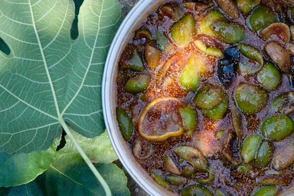 Fig and lemon jam. Fig leaves. Copy space. Top view.