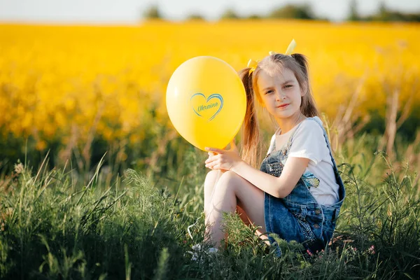 Dívka Sedí Trávě Drží Žlutý Balón Nápisem Ukrajina Přeji Vlasti — Stock fotografie