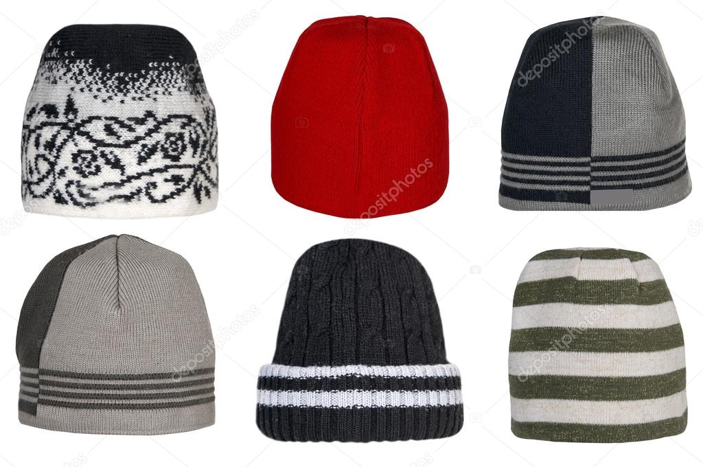Collection of winter knitted woolen hats on a white background.