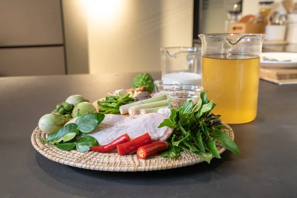 Tavuk kanatları, kırmızı biber, kaffir limon yaprakları ve limon otundan oluşan malzemeler ünlü bir Tayland yemeği olan Yeşil Köri için pişirilmeye hazırlandı.. 