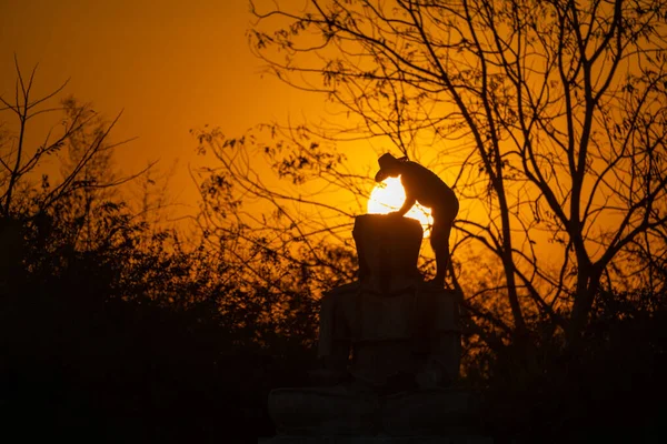 シルエット仏像とアジアの労働者は 彼は夕暮れの日没の背景に仏像を作業し 鋳造しています — ストック写真
