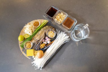 Pad Thai 'nin Düz Masası' nda erişte, karides, sarımsak soğanı, tofu, biber tozu, soğan, balık sosu, palmiye şekeri gibi ana malzemeler bulunur..