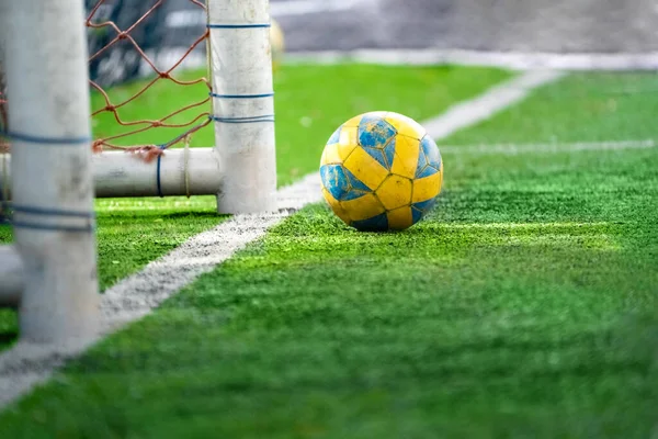 Yellow Football Soccer Ball Lying Artificial Grass Little Sun Ray — стоковое фото
