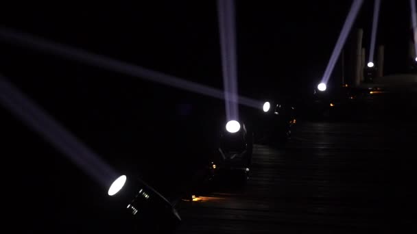 Spotlight Machines Create Light Beams Moving Its Direction Dark Night — Vídeos de Stock