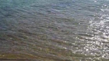 Small little wave on transparence pure water sea on beach with reflection of sunlight