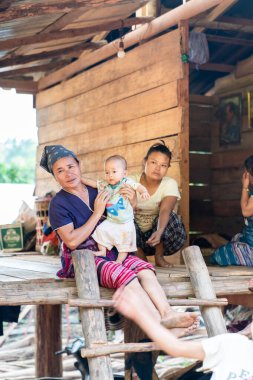 Chiang Mai, Thailand  25 May 2021 - Hill tribe Family with their home. They live in Omkoi Districk, Chiangmai Province, Thailand.