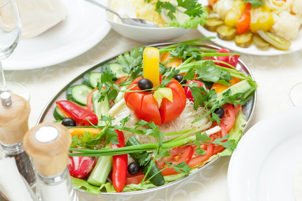 Elegant table setting in restaurant with dishes full of food for celebration