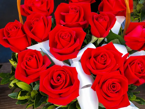 Bright red roses in basket — Stock Photo, Image
