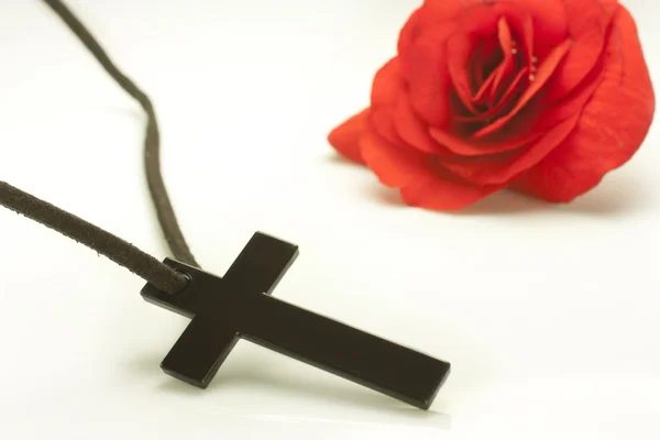 Crucified and red flower — Stock Photo, Image