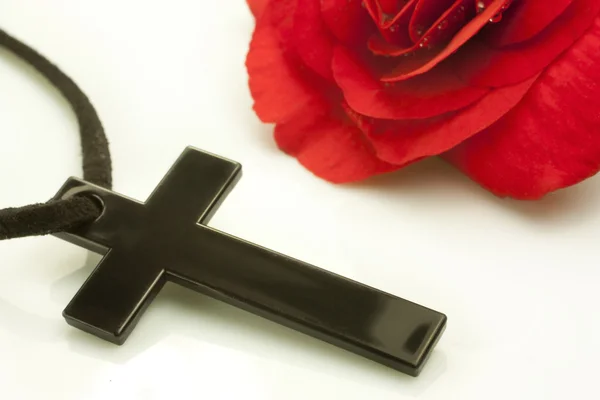 Crucified and red flower — Stock Photo, Image