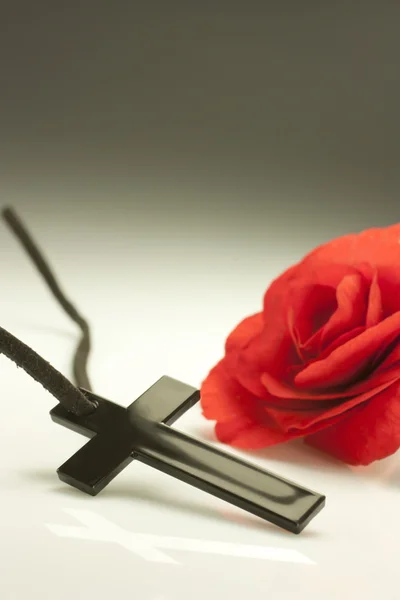 Crucified and red flower — Stock Photo, Image