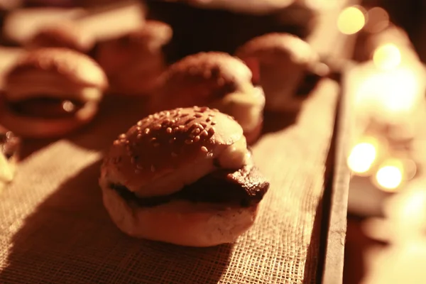 Hamburger sliders on a rustic cutting wooden board. — Stock Photo, Image