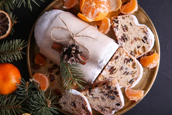 Classical Stollen is a Traditional German Cake with raisins and tangerines on dark background. Fruit cake for the Holiday. — Stock Photo, Image