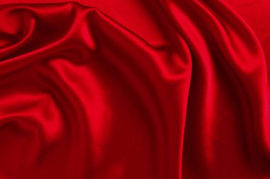 Kırmızı ipek ya da saten lüks kumaş dokusu soyut bir arka plan olarak kullanılabilir. Üst görünüm.