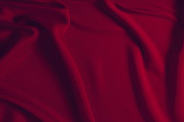 Kırmızı ipek ya da saten lüks kumaş dokusu soyut bir arka plan olarak kullanılabilir. Üst görünüm.