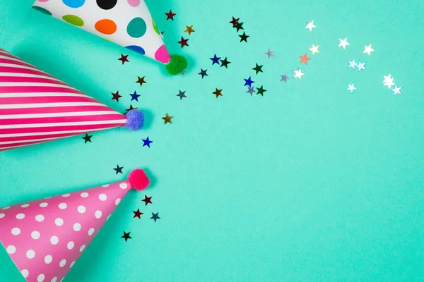 Colorful birthday caps on a blue background. Top view. Copy space.