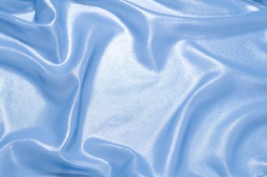 Arka plan olarak mavi parlak inci kumaş. Üst görünüm. 