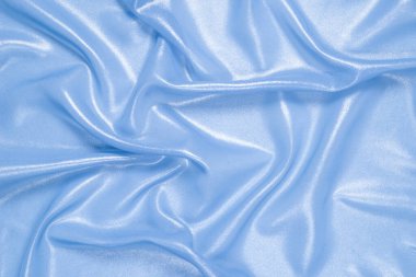 Arka plan olarak mavi parlak inci kumaş. Üst görünüm. 